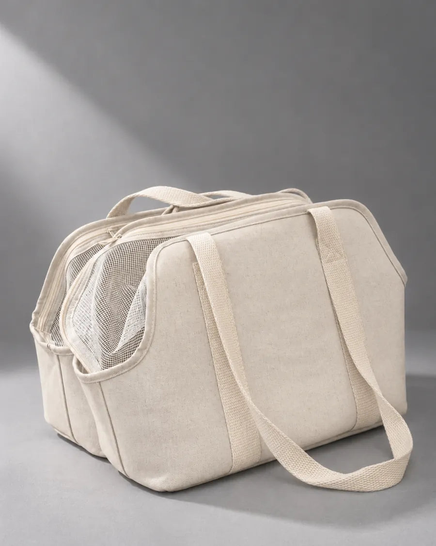 A cream pet carrier in a clean cool-grey studio with directional light