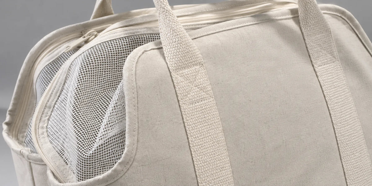 Close view of the pet carrier's canvas, mesh and woven webbing details